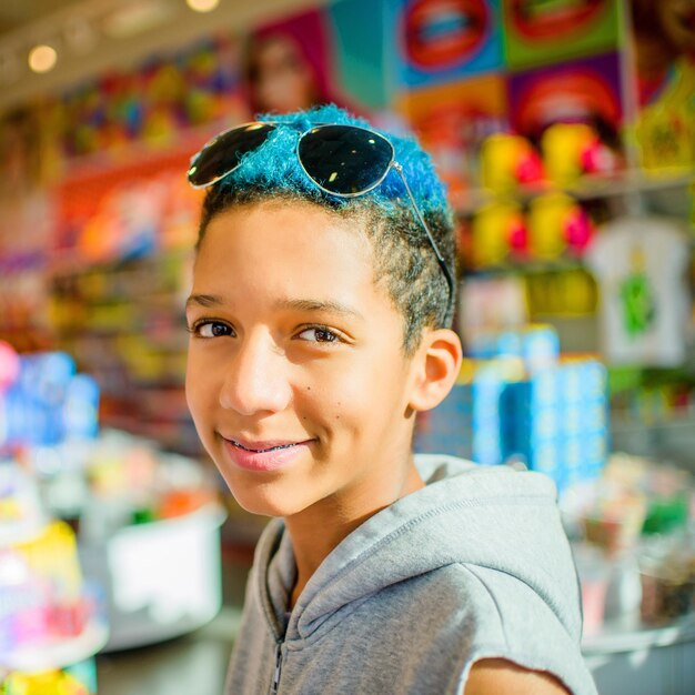 A young Brazilian boy, approximately 12 years old, working in a street market, his expression reflecting a mix of tiredness and resignation. In the background, the vibrant colors of fruits and vegetables contrast sharply with the boy's worn clothing. The composition captures the harsh reality faced by many children in Brazil who must work to support their families instead of attending school.