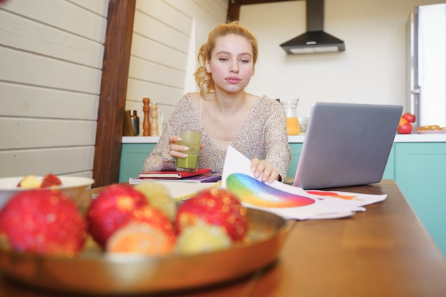 A teenage girl independently studying at her desk with a laptop and books, showcasing self-directed learning. The room is well-lit and organized, promoting a conducive environment for studying.
