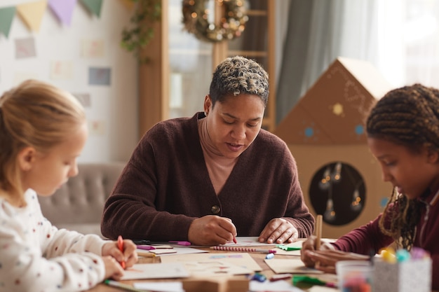 A diverse group of parents are actively participating in a workshop at their children's early childhood education center, learning about child development and how to support their learning at home.