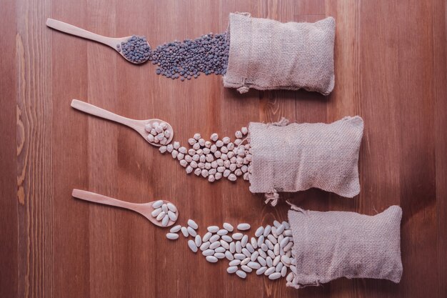 A close-up of different types of fertilizers are displayed, some bags are torn open with fertilizer exposed to the elements.