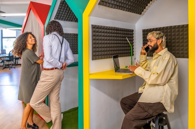 A vibrant scene in a modern co-working space in Rio de Janeiro, where a group of young Brazilian writers collaborate on a new digital literary platform. They are surrounded by laptops, tablets, and sketches, showcasing the blend of traditional writing methods with cutting-edge technology. The atmosphere is energetic and collaborative, epitomizing the future of Brazilian literature.