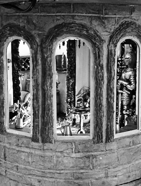 A historical black and white image of a Candomblé terreiro (house of worship) from the early 20th century, showing the layout, altars with offerings, and practitioners in traditional clothing.