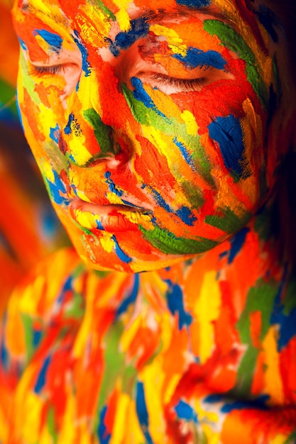 A close-up shot of a painting featuring vibrant colors and patterns inspired by Brazilian indigenous art. The artwork conveys a sense of cultural richness and connection to ancestral traditions.