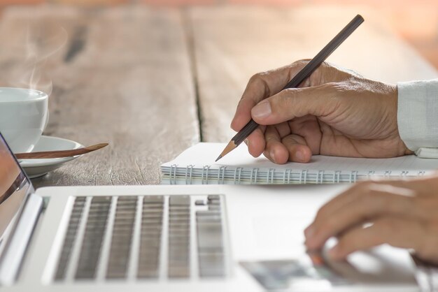 A close-up shot on hands filling out HSA contribution forms on a desk with a calculator and pen, emphasizing the process of planning contributions.