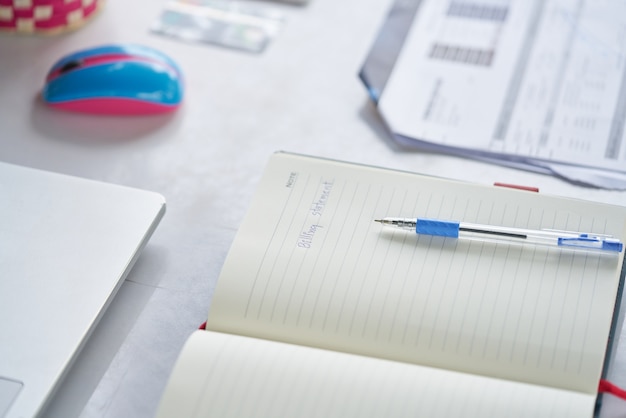 A close-up shot of SAT and ACT test booklets, with a pen resting on top. The background is blurred, creating a sense of focus on the importance and weight of these exams in the college application process.