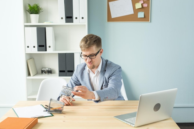 A person sitting at a desk reviewing financial documents and using a calculator, symbolizing the need to understand the new 401(k) catch-up contribution rules and adjust financial planning accordingly.