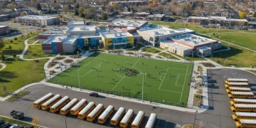 Modern public school campus with students, reflecting federal funding impact
